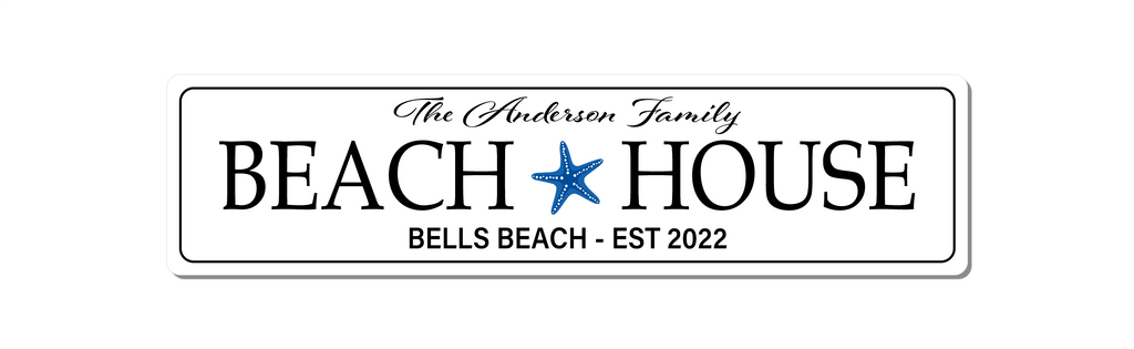 White with black text beach house sign